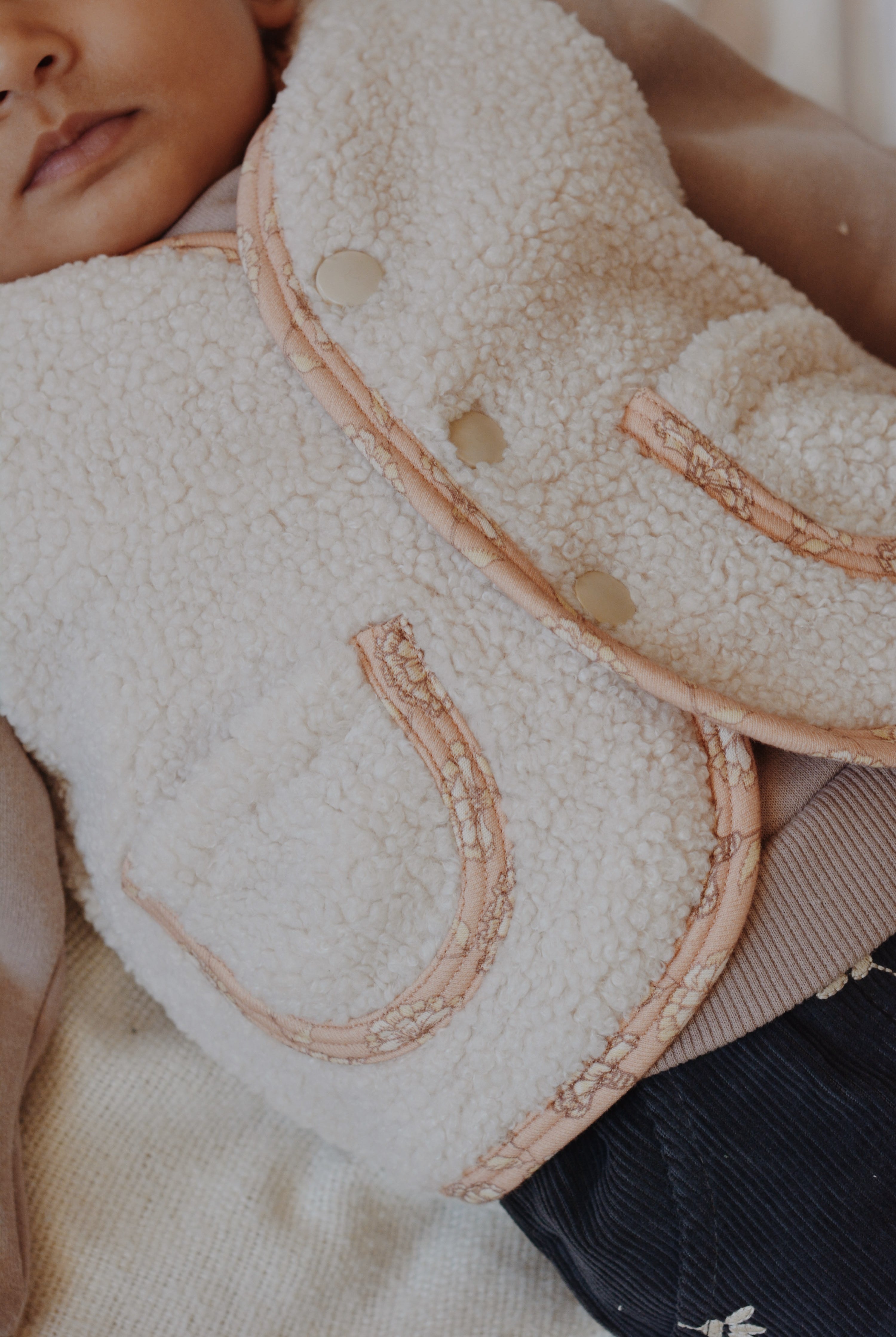 Rosalie Teddy Vest Close-Up – Soft Pink Floral Lining on Cream Sleeveless Baby Vest, Comfortable and OEKO-TEX Certified