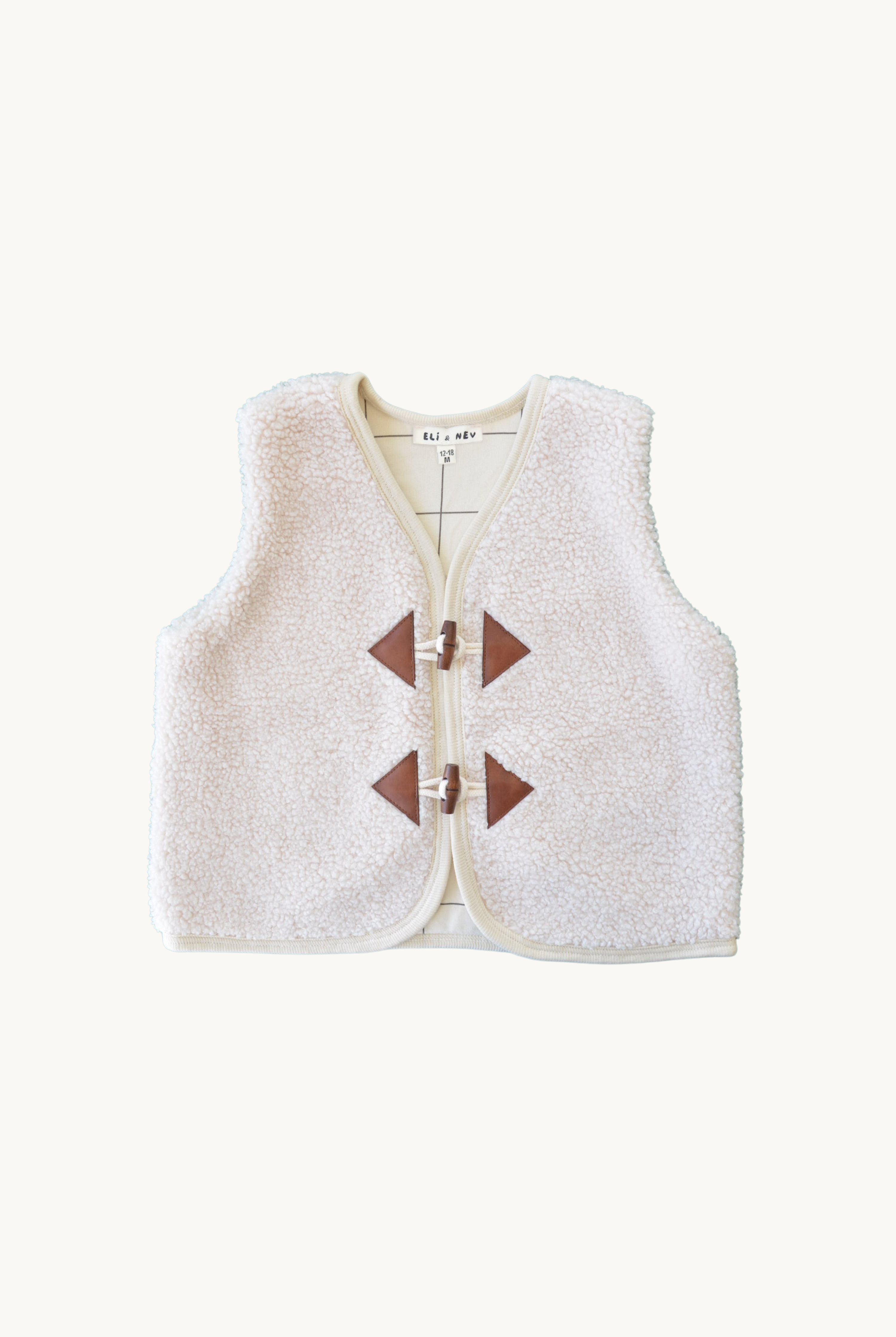 A sleeveless vest with a teddy texture, featuring toggle closures and a check pattern on the lining, primarily in beige and grey tones.