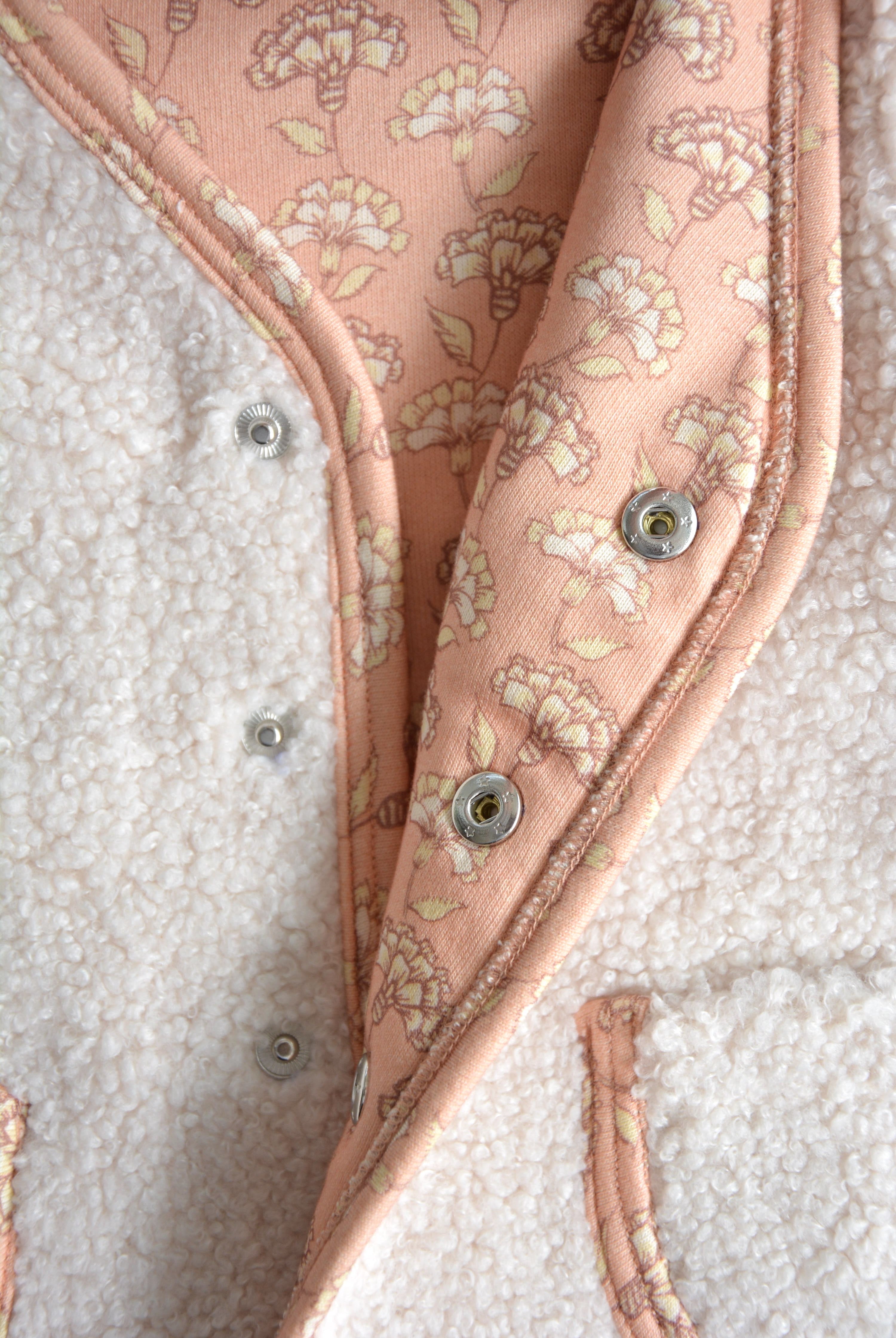 Rosalie Teddy Vest Close-Up – Soft Pink Floral Lining on Cream Sleeveless Baby Vest, Comfortable and Sustainable