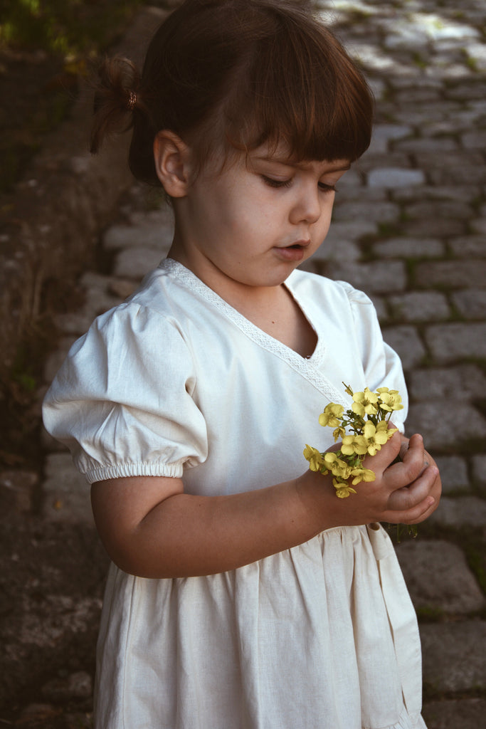 little girl holding wild flowers