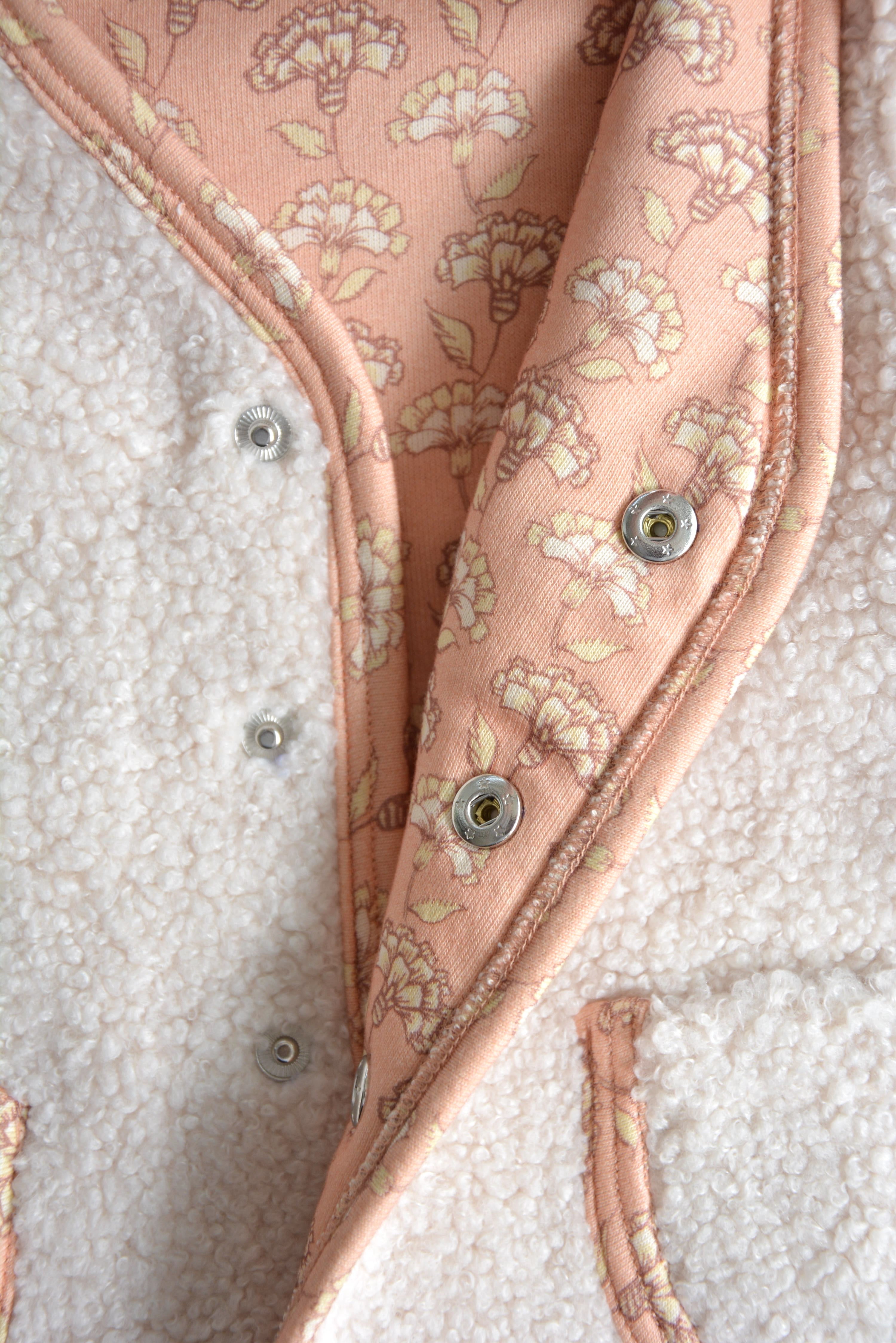 Rosalie Teddy Vest Close-Up – Soft Pink Floral Lining on Cream Sleeveless Baby Vest, Comfortable and Sustainable 
