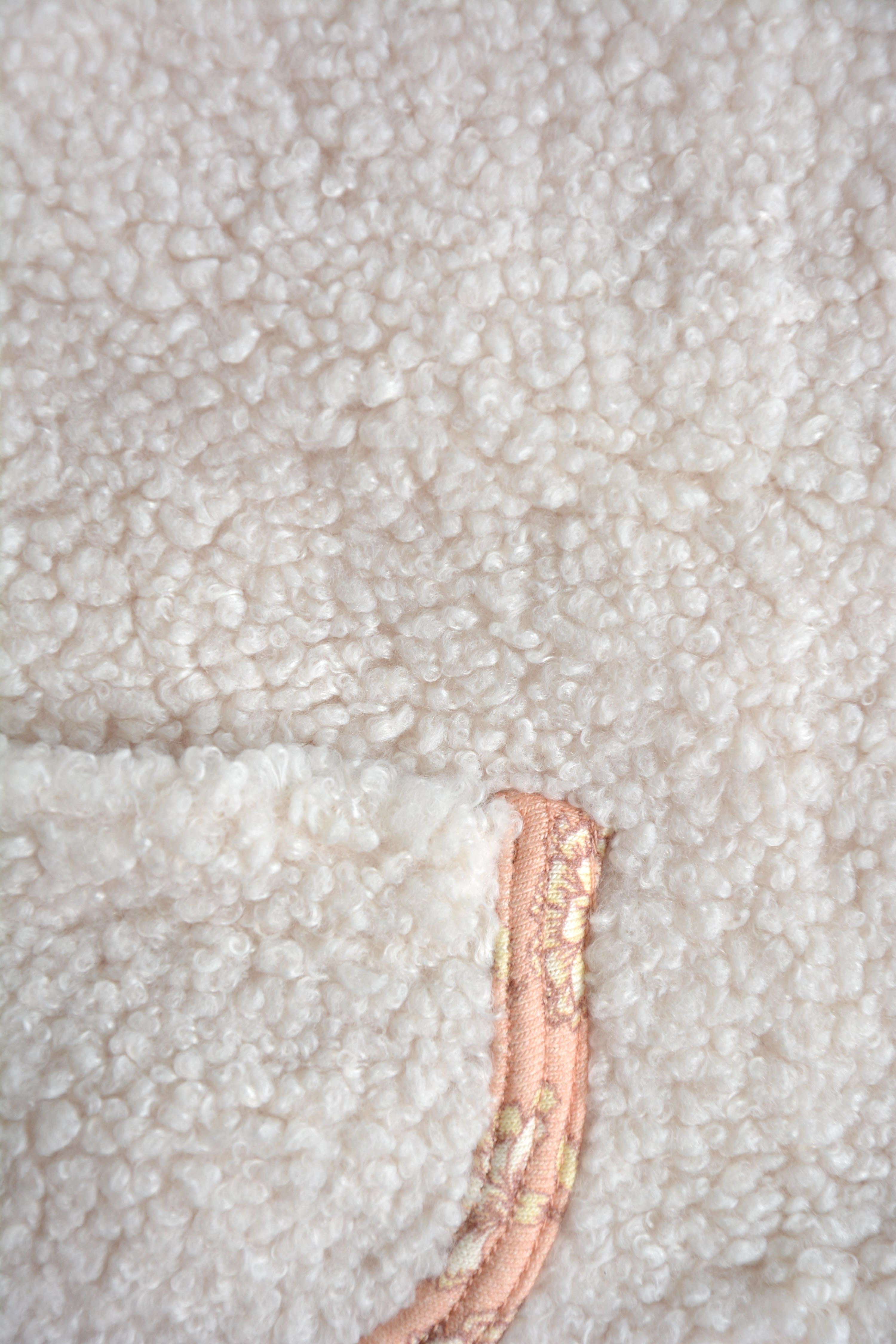 Close up of Rosalie Teddy Vest – Cozy Cream Sleeveless Baby Vest with Pink Floral Lining, Perfect Fall & Winter Layering
